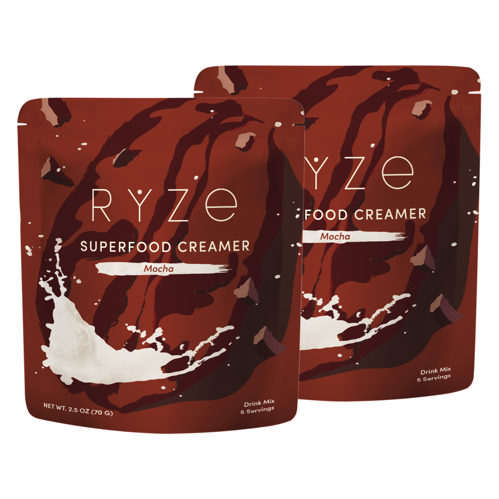 Two pouches of RYZE Food Creamer Superfood Creamer in Mocha flavor, displayed against a plain white background.