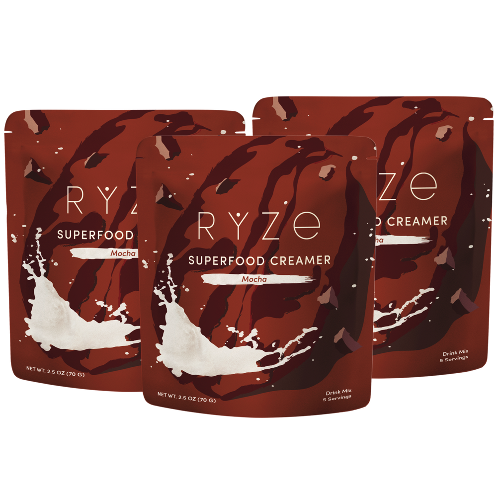 Three stand-up pouches of RYZE Superfood Creamer in Mocha flavor, arranged in a fan-like composition on a plain white background.